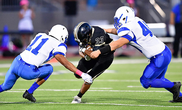 Football Player Making A Tackle